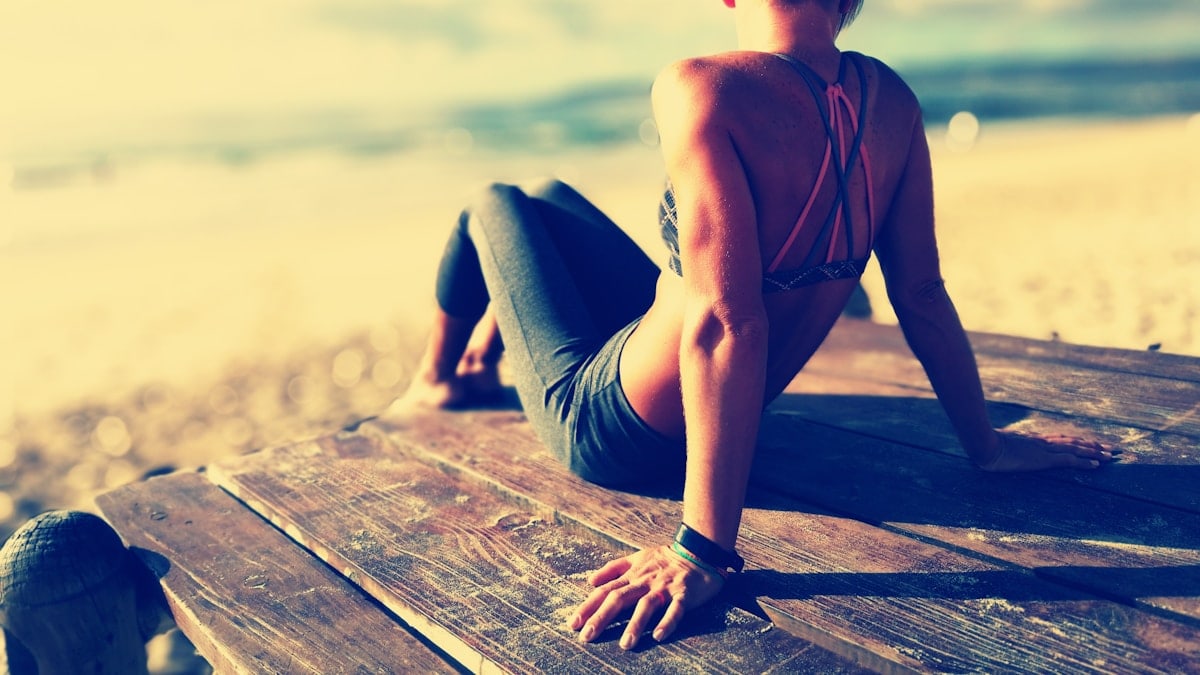 woman wearing fitted pants and sports bra